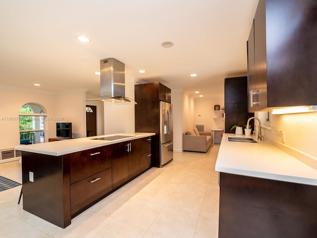 kitchen with island exhaust hood, black electric stovetop, crown molding, stainless steel refrigerator, and sink