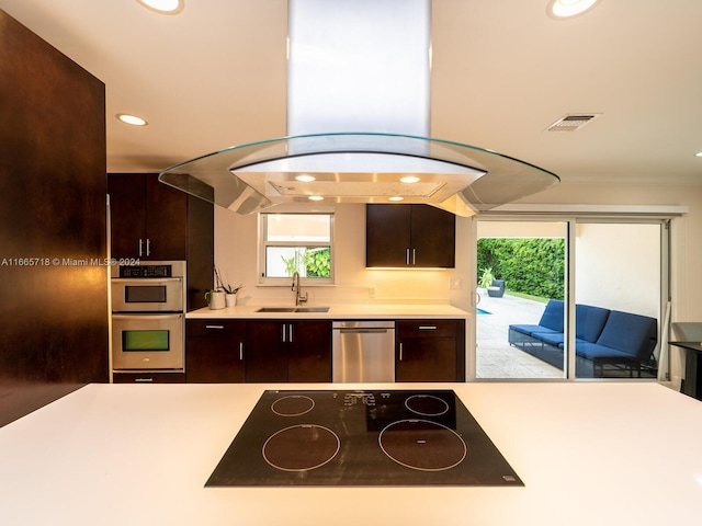 kitchen featuring dark brown cabinetry, appliances with stainless steel finishes, sink, and island exhaust hood