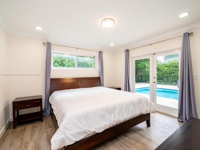 bedroom featuring access to outside, crown molding, and light hardwood / wood-style flooring