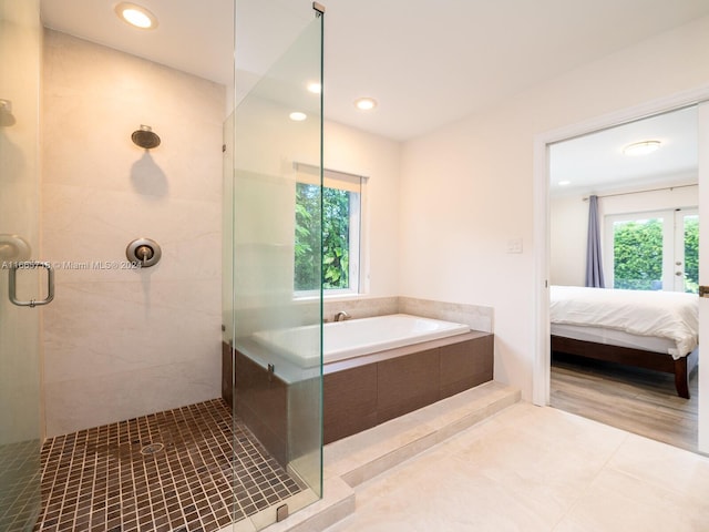 bathroom with independent shower and bath and tile patterned flooring