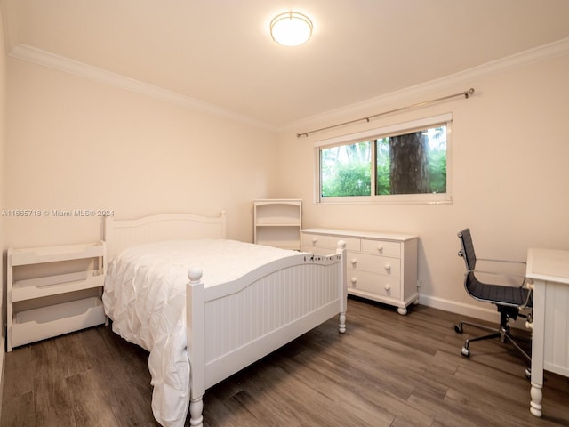 bedroom with ornamental molding and dark hardwood / wood-style floors