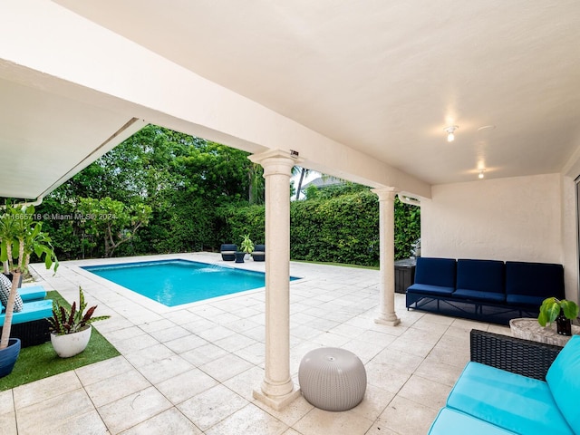 view of pool featuring an outdoor living space and a patio area