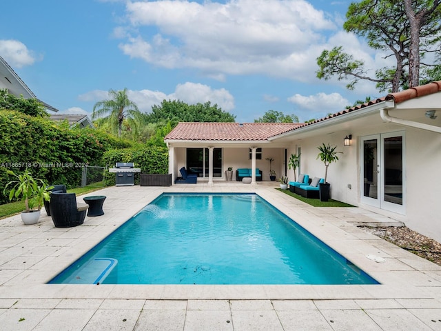 view of swimming pool featuring grilling area and a patio area