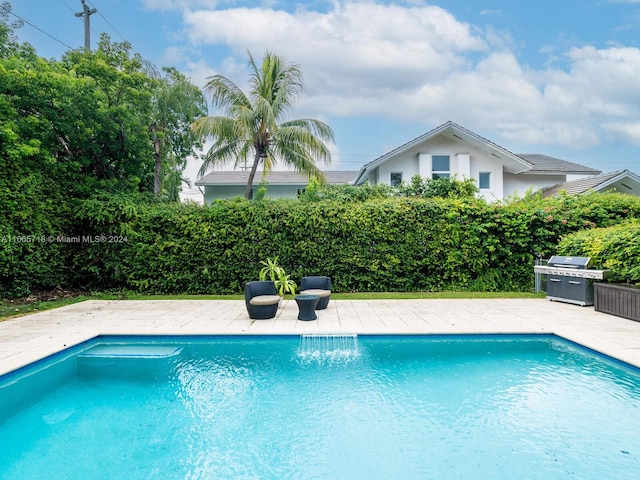 view of swimming pool featuring a patio