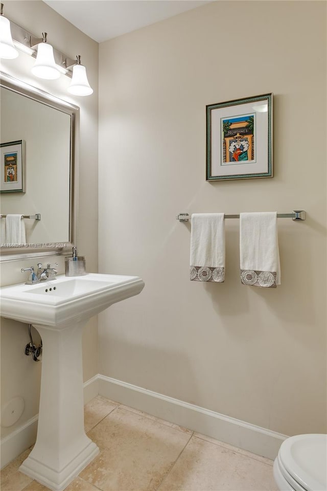 bathroom with tile patterned flooring and toilet