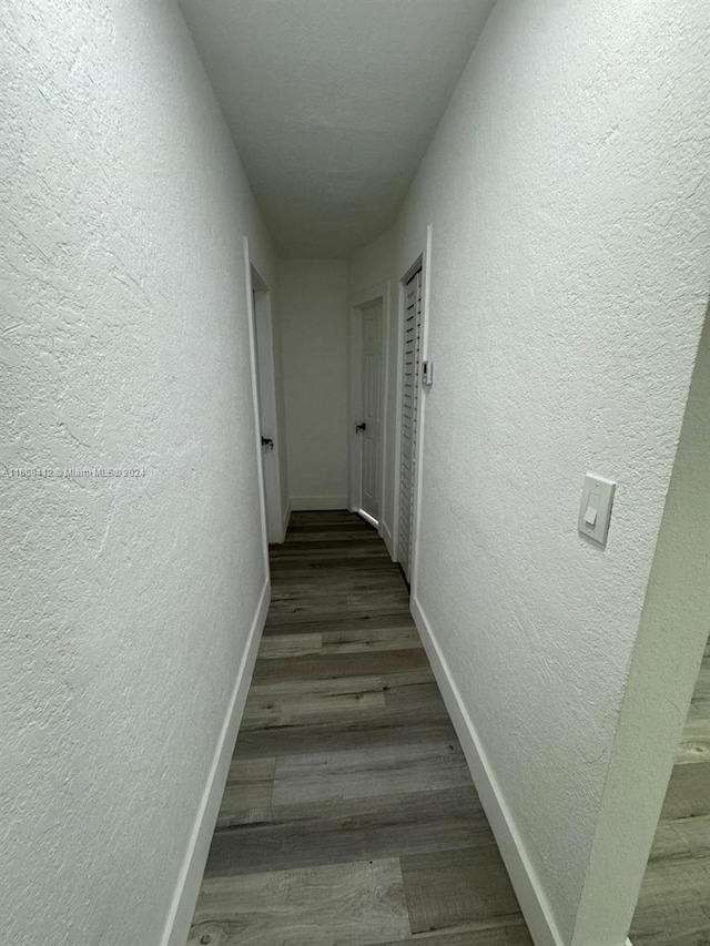 corridor with dark hardwood / wood-style floors