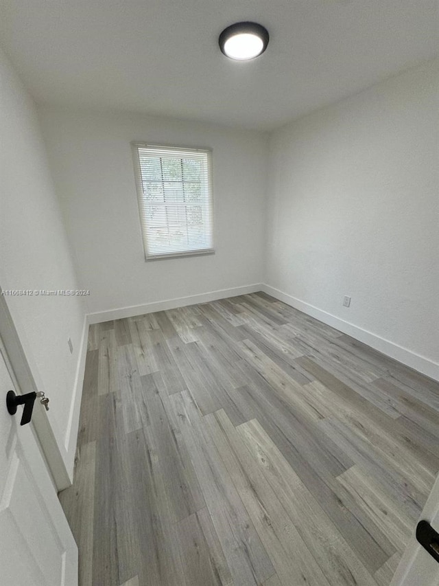 spare room with light hardwood / wood-style floors