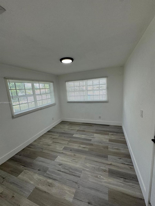 unfurnished room featuring light hardwood / wood-style flooring and a healthy amount of sunlight