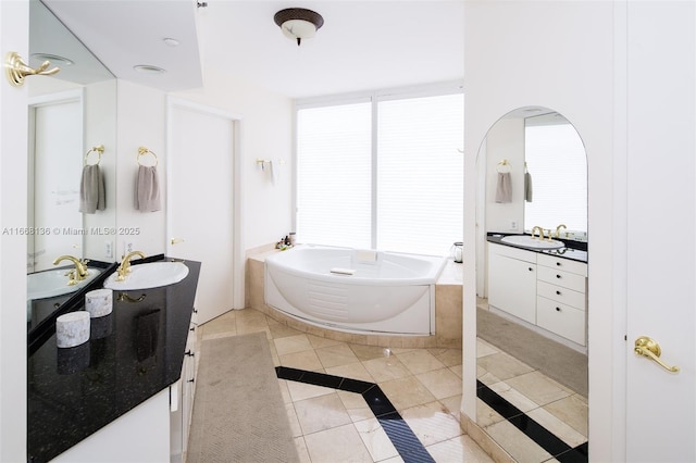 bathroom with vanity, a bath, and tile patterned flooring