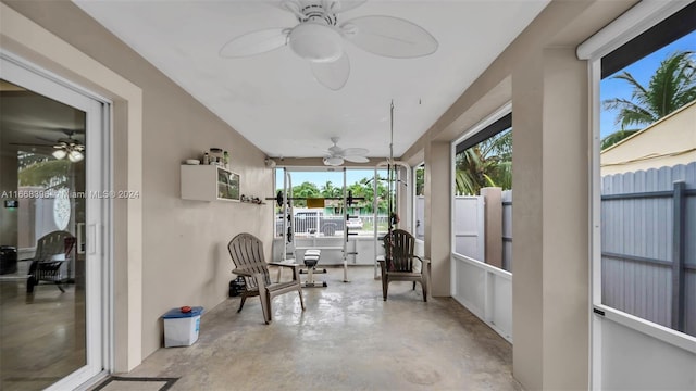 sunroom featuring ceiling fan