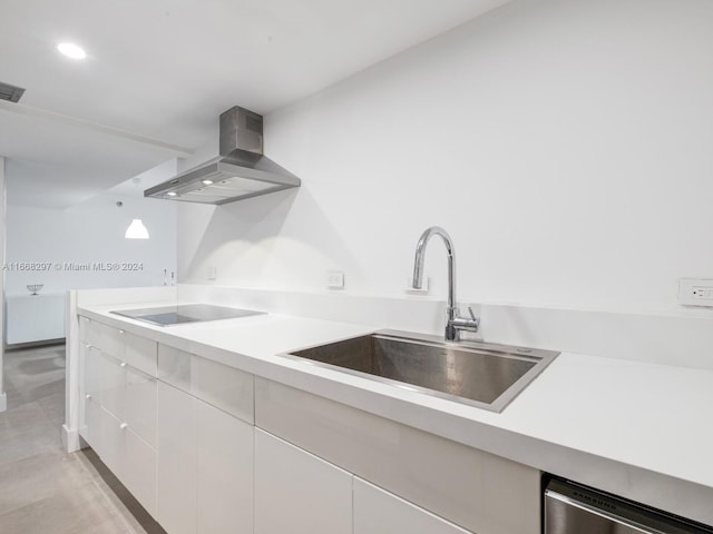 kitchen featuring black electric cooktop, white cabinets, wall chimney exhaust hood, sink, and dishwasher