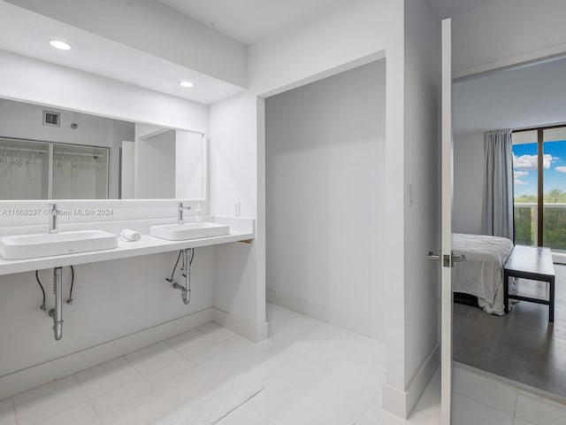 bathroom featuring tile patterned flooring and vanity