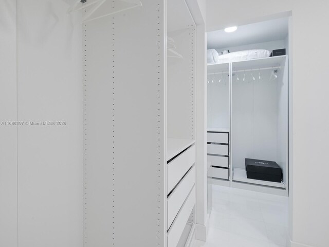 spacious closet featuring light tile patterned floors