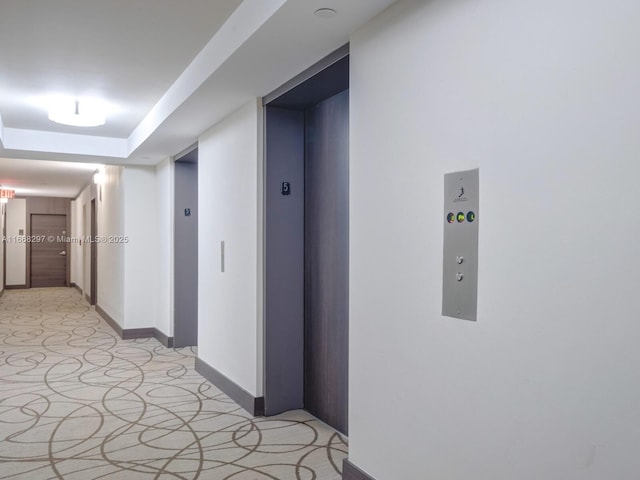 20505 E Country Club Dr Unit 531, Aventura, FL 33180 - hall with a raised ceiling, elevator, and baseboards