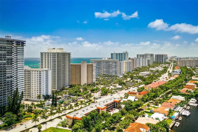 birds eye view of property with a view of city and a water view