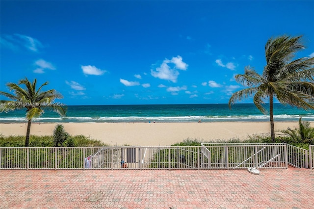 water view featuring a view of the beach and fence