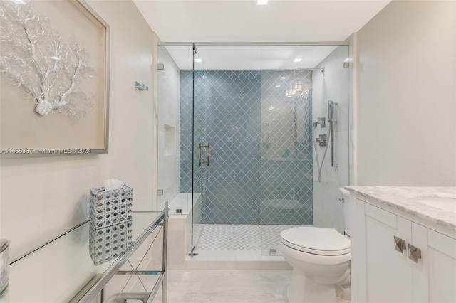 bathroom featuring toilet, vanity, and a shower stall