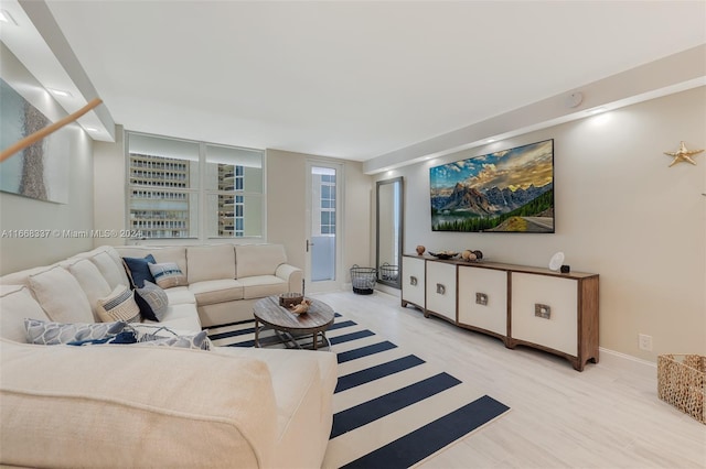 living room with light wood-style flooring and baseboards