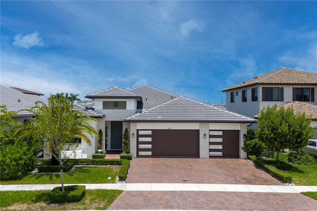 view of front of property with a garage and a front yard