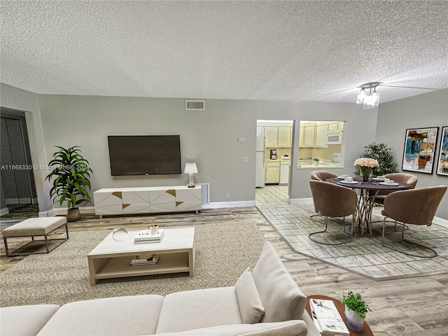 living room with a textured ceiling and hardwood / wood-style flooring