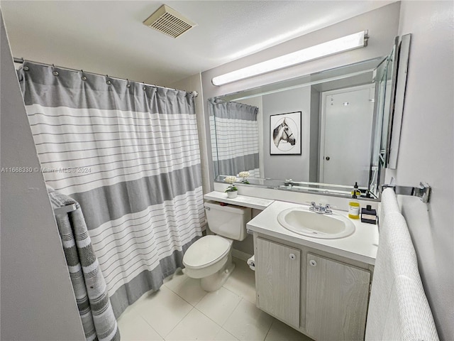 bathroom featuring walk in shower, vanity, toilet, and tile patterned floors