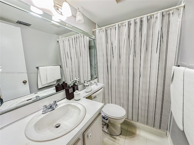 bathroom with tile patterned floors, a shower with curtain, vanity, and toilet