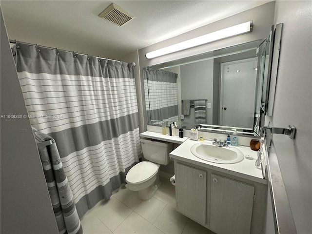 bathroom featuring vanity, toilet, a shower with shower curtain, and tile patterned floors