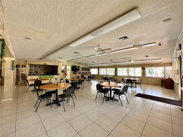 tiled dining area featuring ceiling fan and a textured ceiling