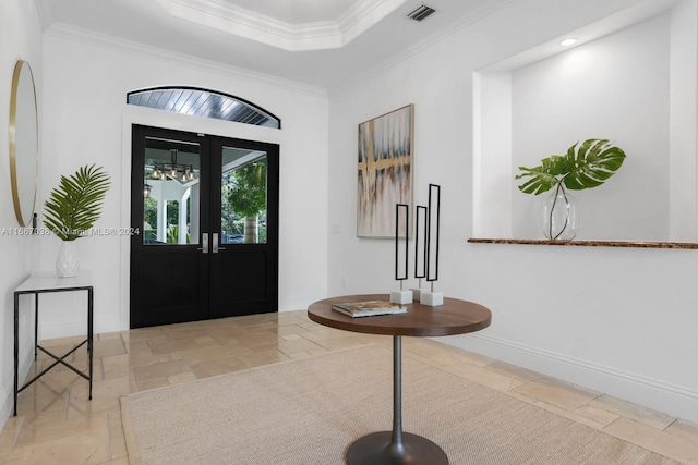 foyer with crown molding and french doors