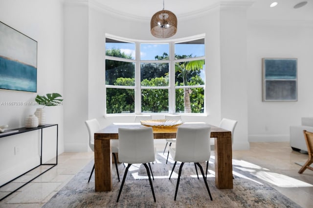 dining space with ornamental molding and a healthy amount of sunlight