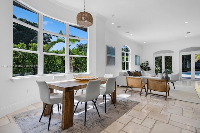 dining space with crown molding, french doors, and a wealth of natural light