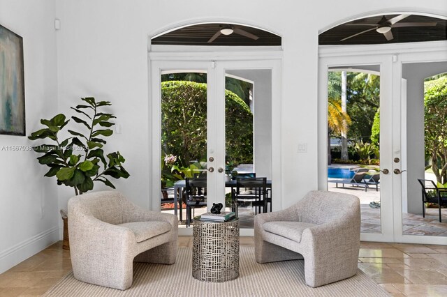 sitting room featuring french doors and ceiling fan