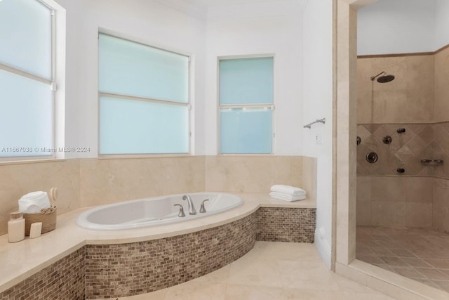 bathroom with independent shower and bath and tile patterned floors