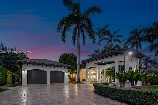 mediterranean / spanish-style home with a garage