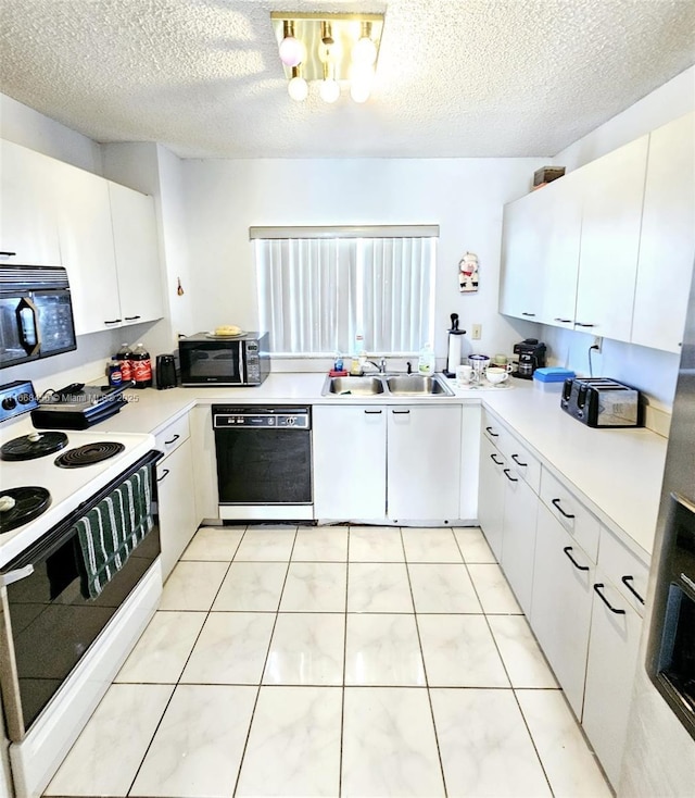 kitchen with white cabinets, black appliances, light countertops, and a sink