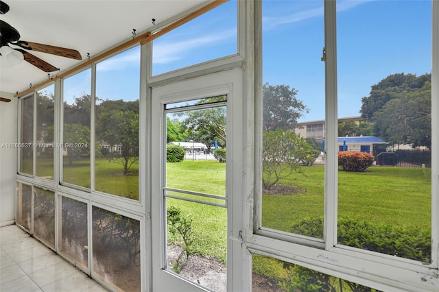 unfurnished sunroom featuring a wealth of natural light and ceiling fan