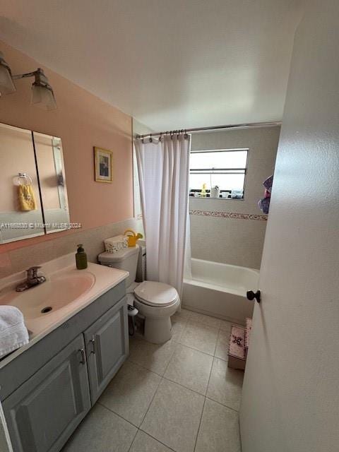 full bathroom featuring vanity, tile patterned flooring, toilet, and shower / bath combo