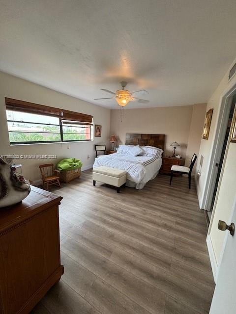 bedroom featuring ceiling fan and hardwood / wood-style flooring