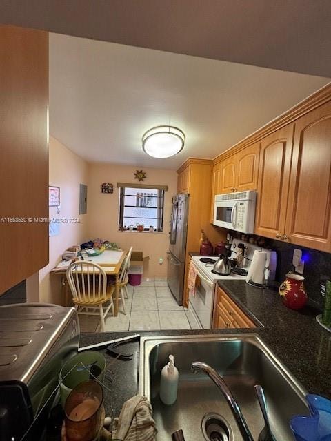 kitchen with light tile patterned floors and white appliances