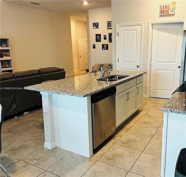 kitchen featuring dishwasher, a center island with sink, white cabinetry, and sink