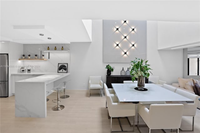 dining area featuring light wood-type flooring