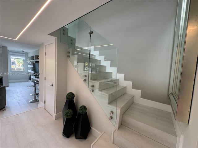 stairs featuring wood-type flooring