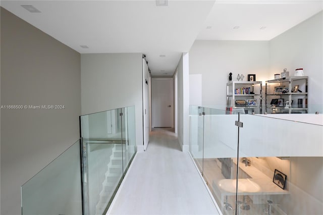 corridor with light hardwood / wood-style flooring