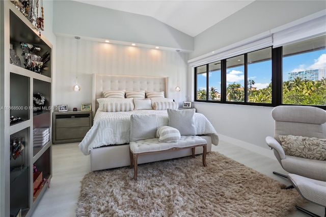 bedroom featuring lofted ceiling and light hardwood / wood-style floors