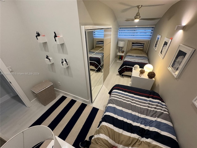 bedroom featuring light hardwood / wood-style floors, vaulted ceiling, and ceiling fan