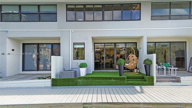 rear view of property featuring a deck and central AC unit