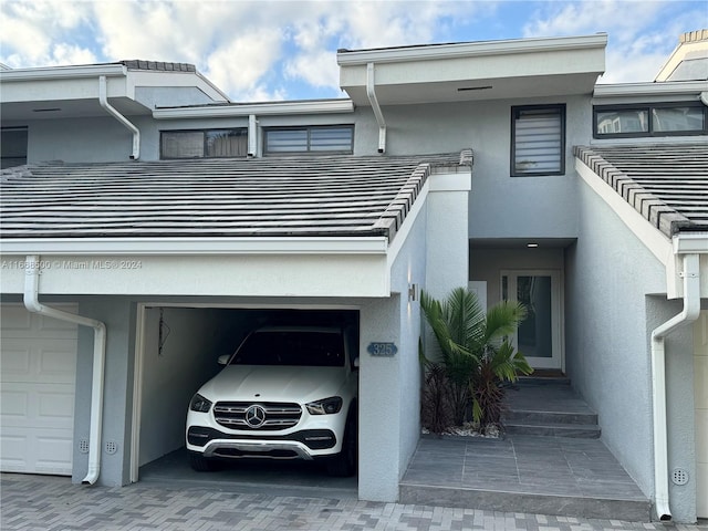 view of front facade featuring a carport and a garage