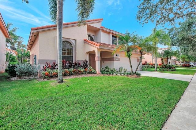 mediterranean / spanish home with a front yard and a garage