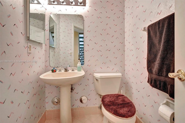 bathroom featuring sink, tile patterned flooring, and toilet