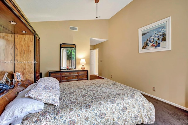 carpeted bedroom with lofted ceiling